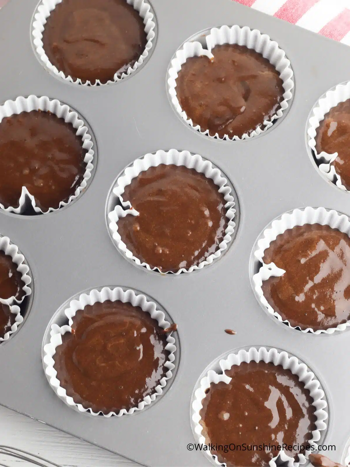 Chocolate cupcake batter in baking tin.
