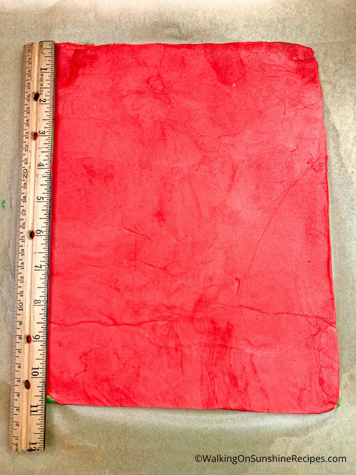 Red cookie dough rolled out.