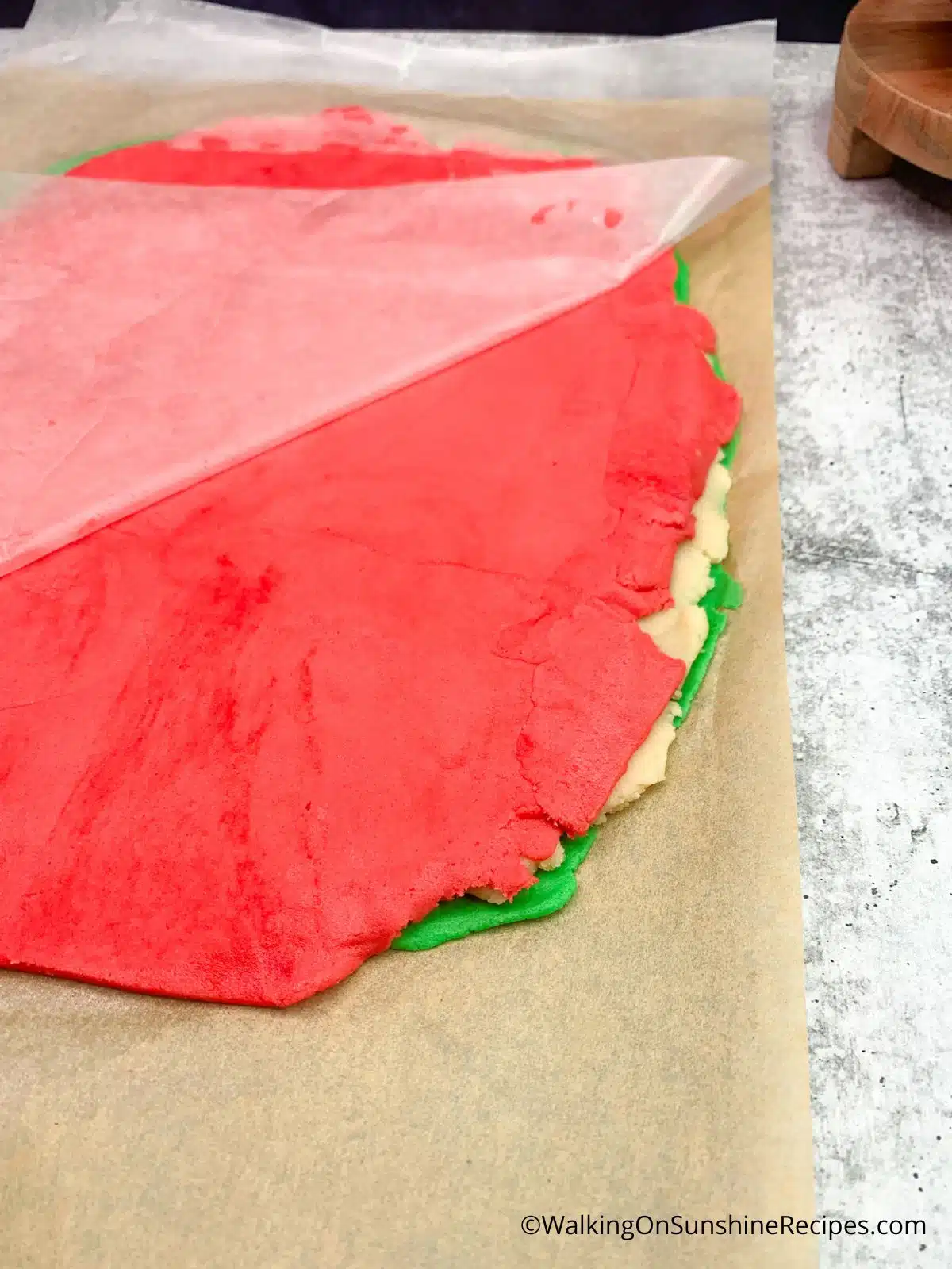 3 sheets of colored dough rolled out on top of each other.