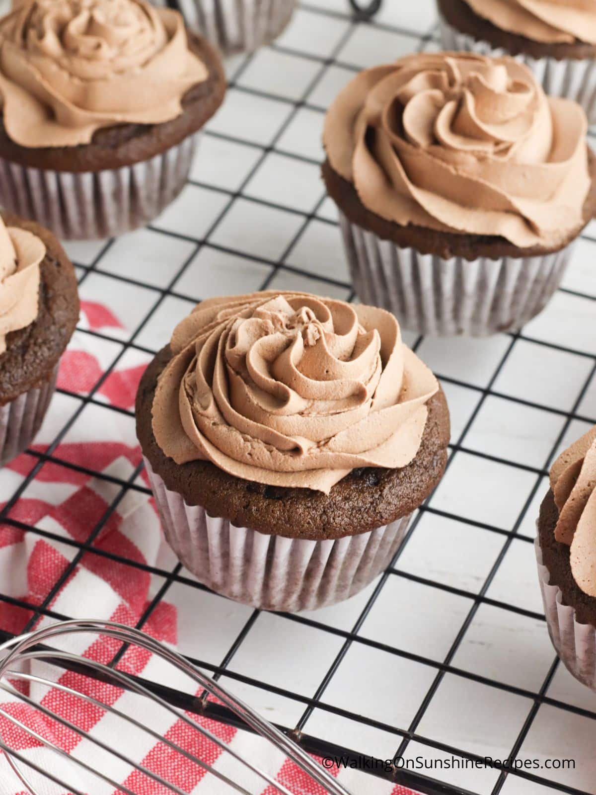 Add chocolate peppermint frosting to top of baked cupcakes.