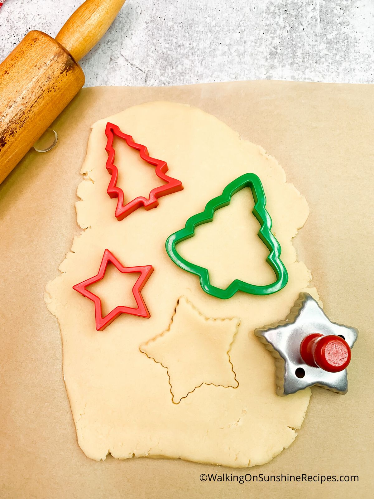 cut out cookies using cookie cutters.