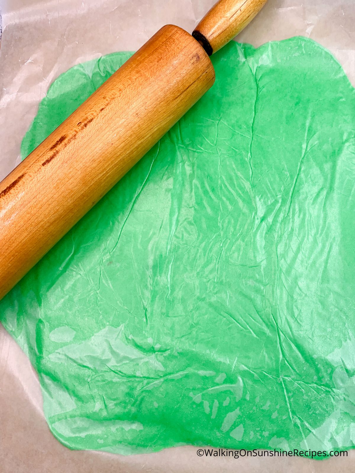 rolled out cookie dough between waxed paper.