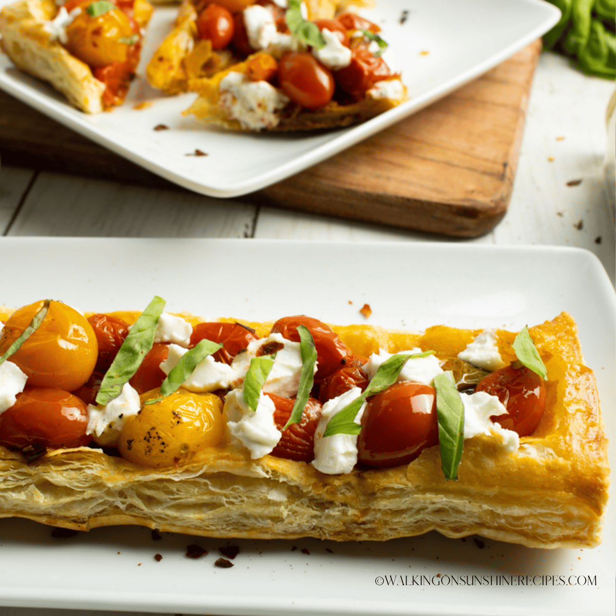 https://walkingonsunshinerecipes.com/wp-content/uploads/2022/12/FEATURED-NEW-SIZE-Puff-Pastry-Tomato-Tart.png