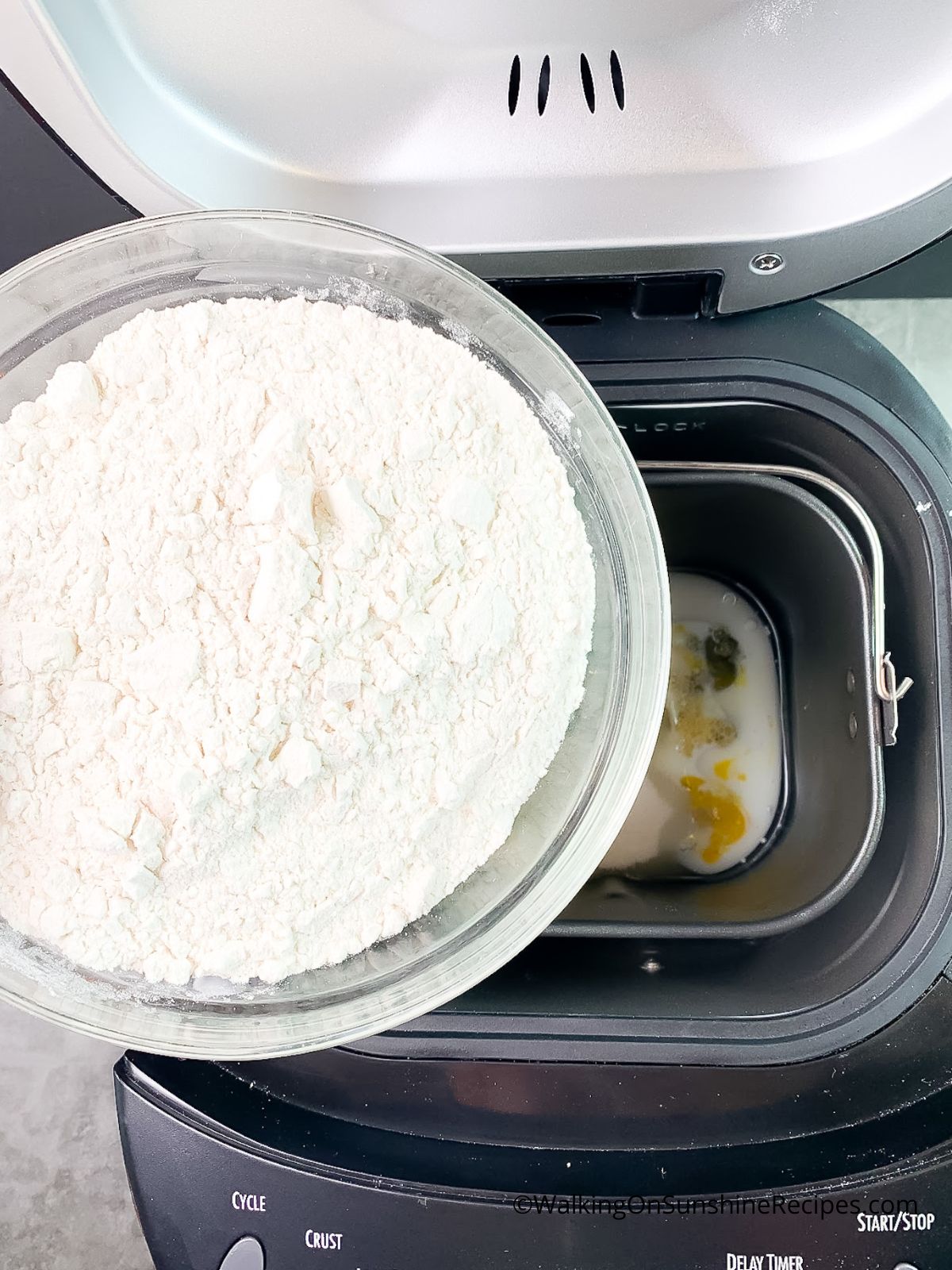 Add flour to bread machine.