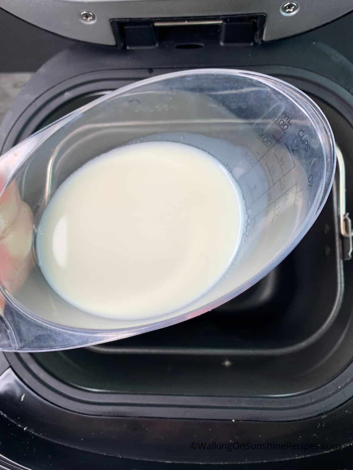 add milk to bread machine.