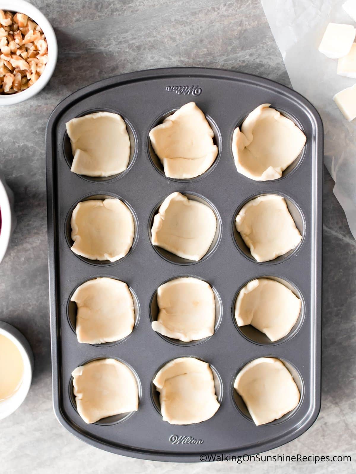 place puff pastry in muffin pan.