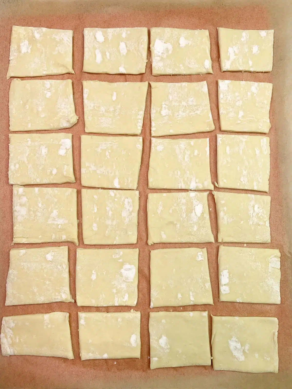 24 squares of puff pastry dough.