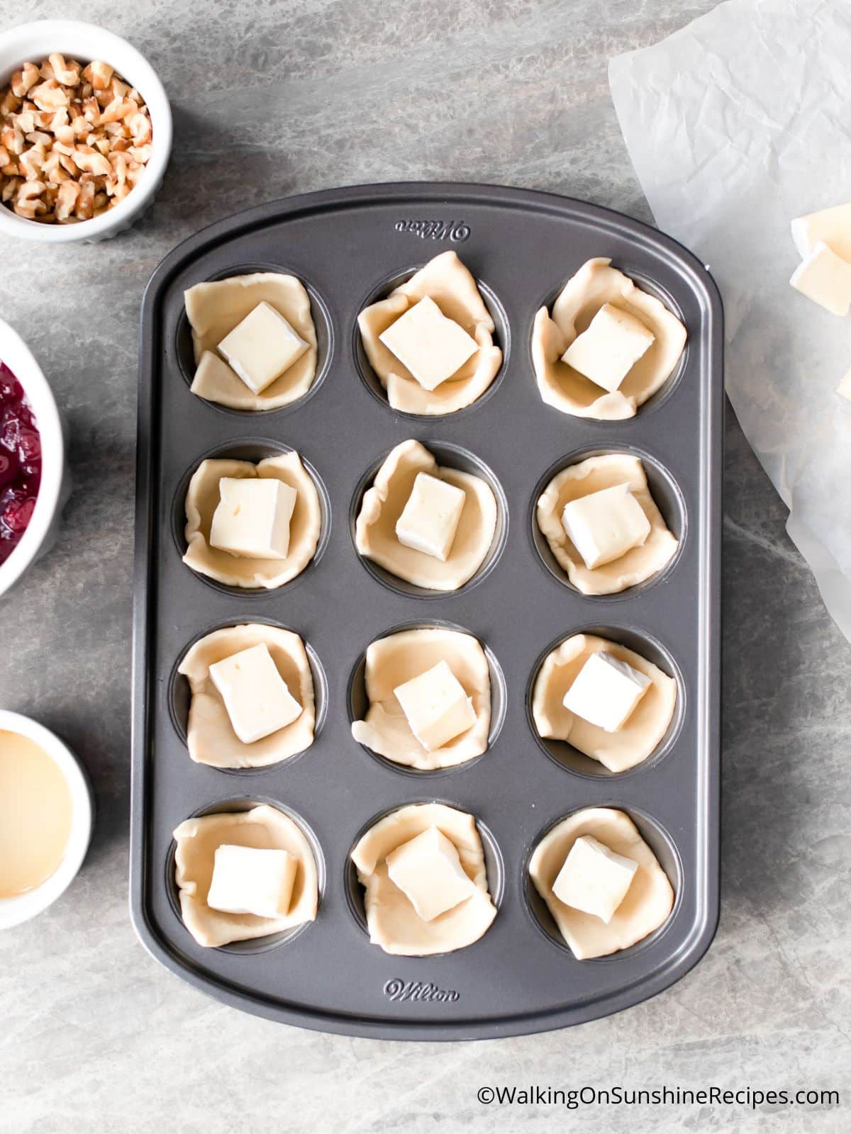 add brie cheese to puff pastry squares.
