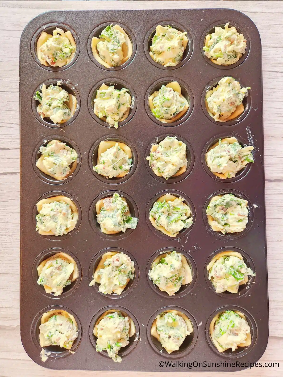 cheese puff pastry in muffin pan with spinach.