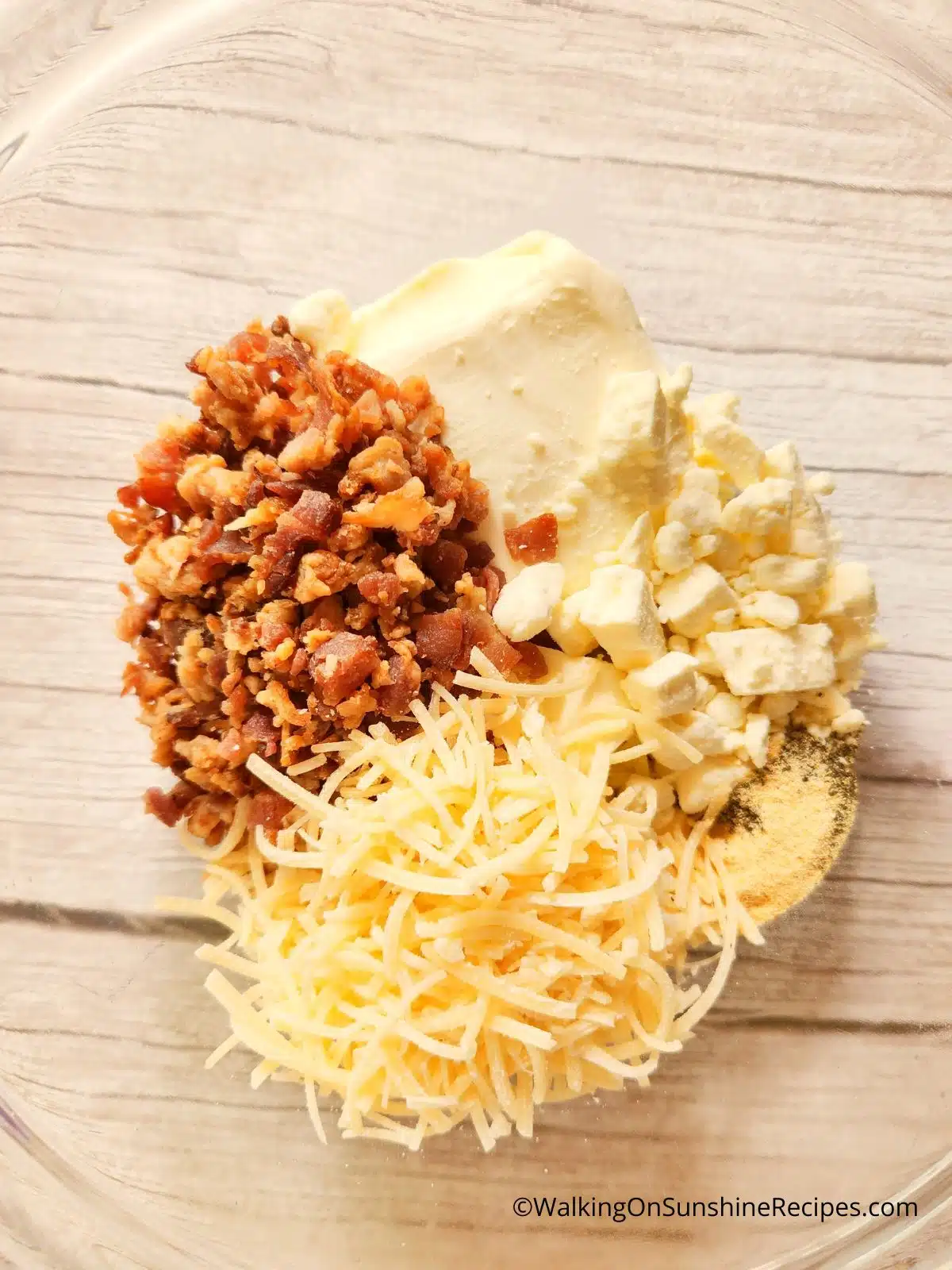 combine cream cheese, white cheddar cheese, bacon and spices together in bowl.