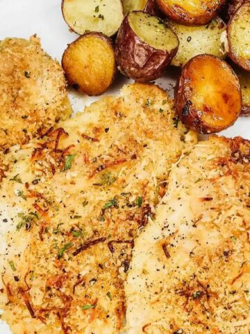 Baked parmesan chicken with roasted potatoes.
