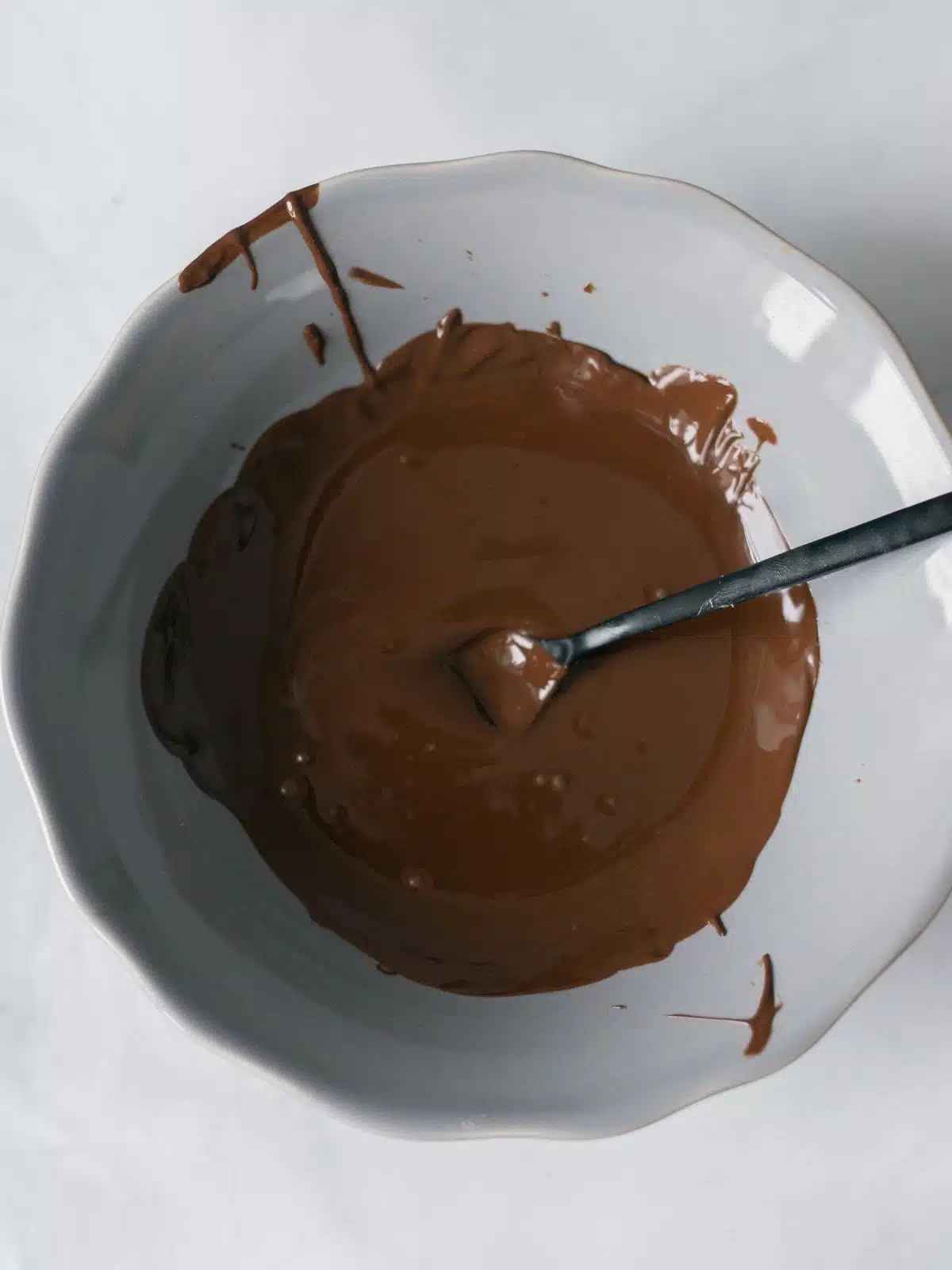 melted chocolate in white bowl with spoon.