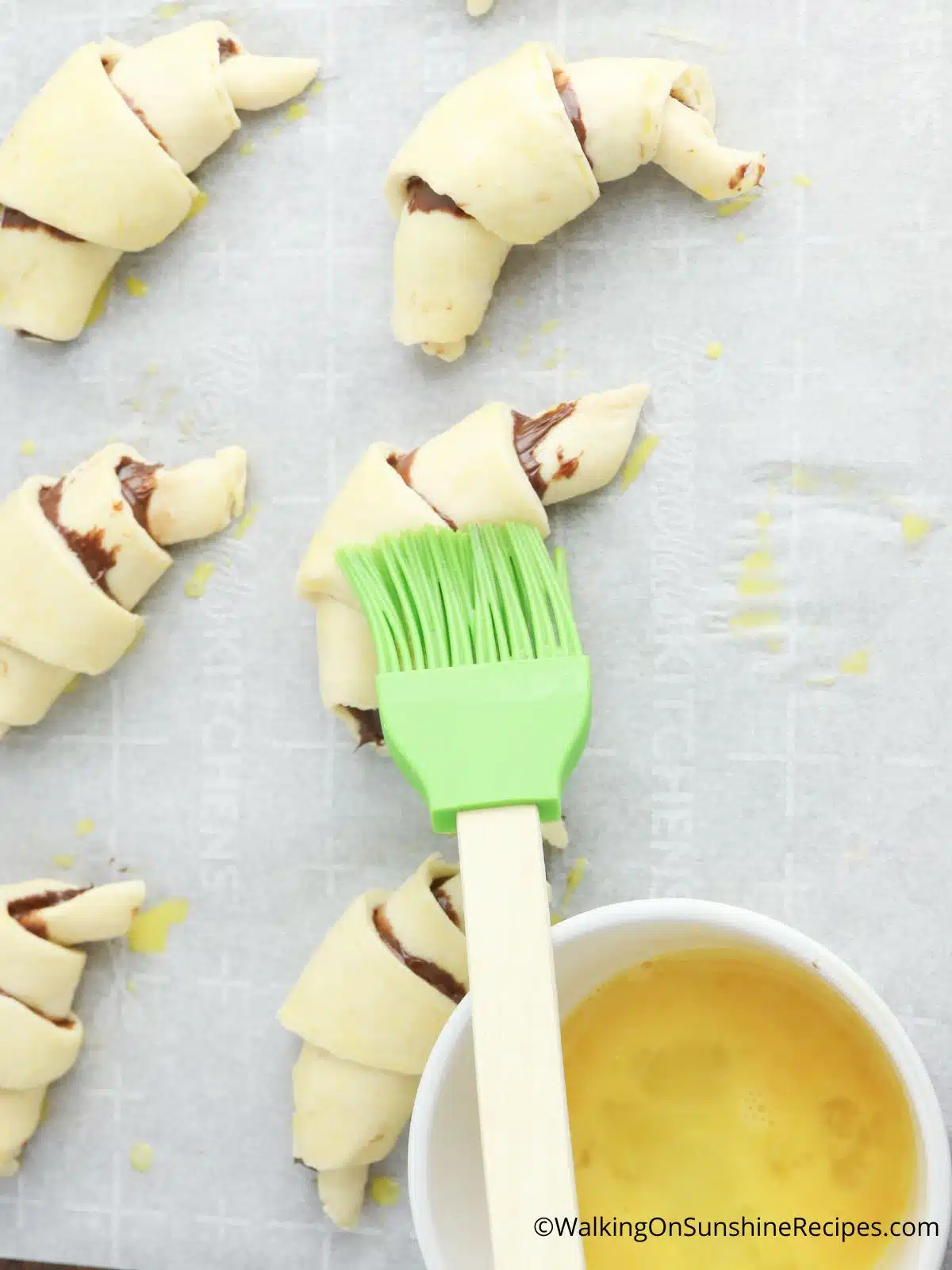 Brush the crescent rolls with beaten egg to make them shine while baking.