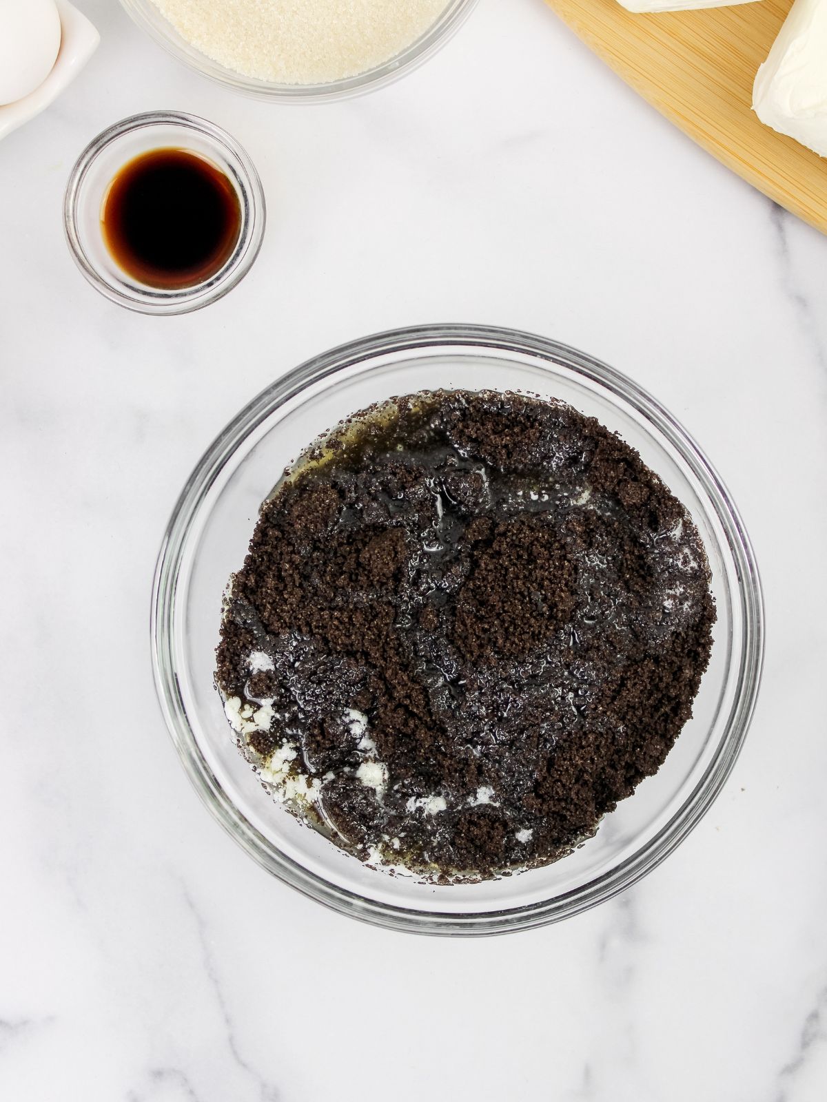 Add melted butter to sugar and Oreo cookie crumbs.
