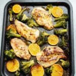 chicken, broccoli and orange slices baked on a sheet pan