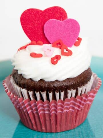 pink and red cupcake with heart candy topper.