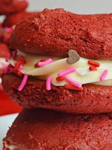 Red velvet cookies with cream cheese frosting and sprinkles.