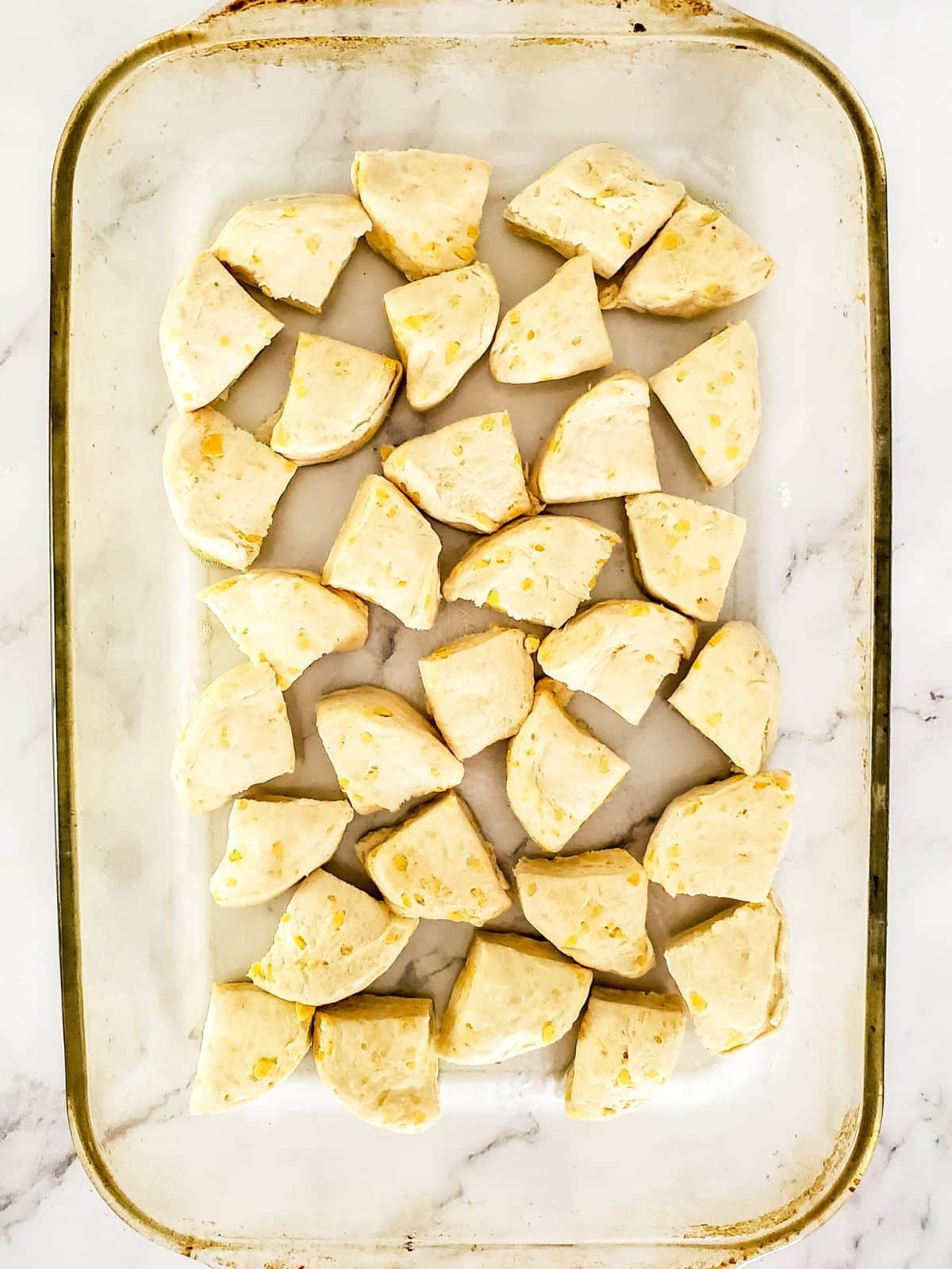 cut up biscuits for dessert casserole.