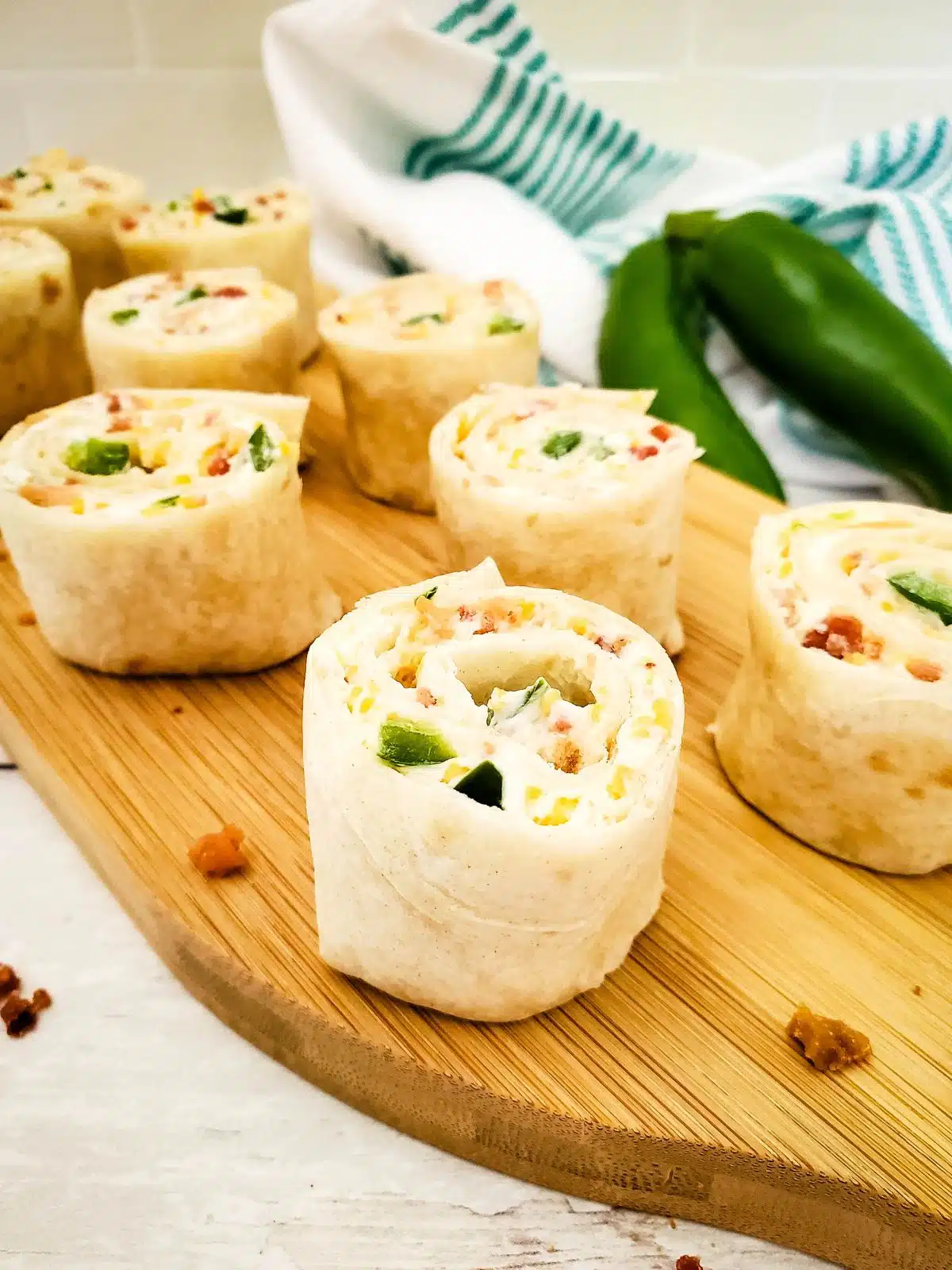 cream cheese tortilla rolls ups cut on cutting board.