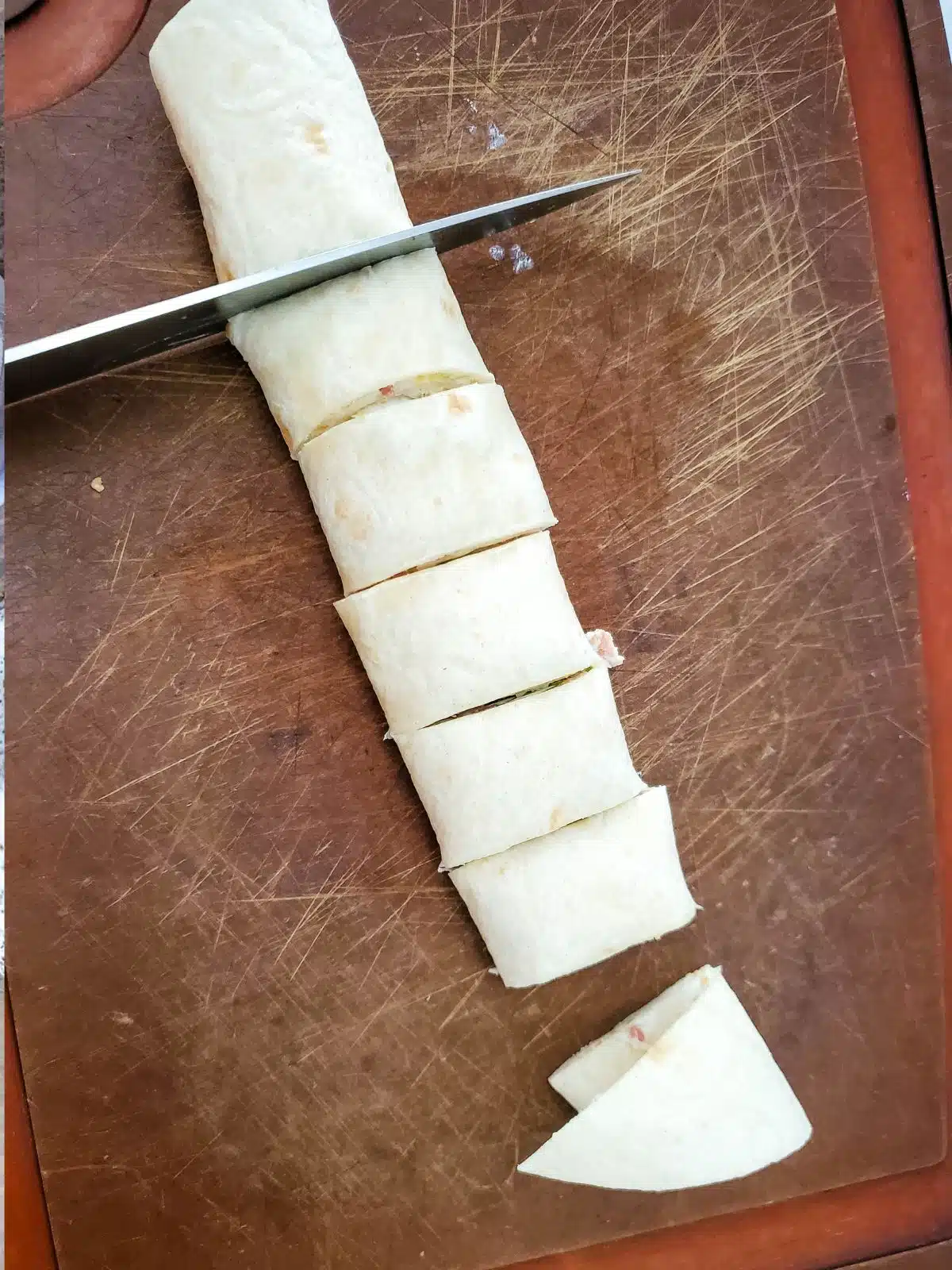 slicing flour tortilla cream cheese appetizer.