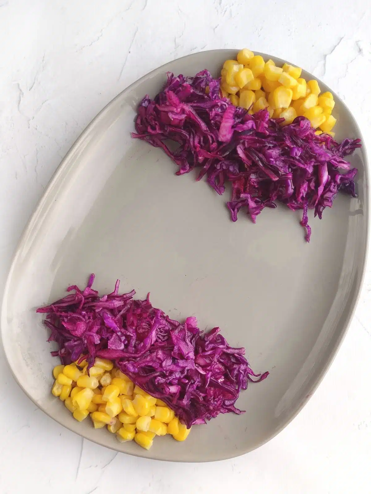 red cabbage and corn on egg shaped plate for salad.