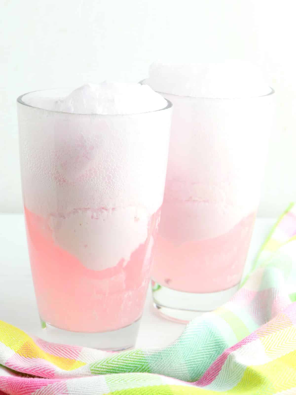 soda with punch in tall glass with ice cream.