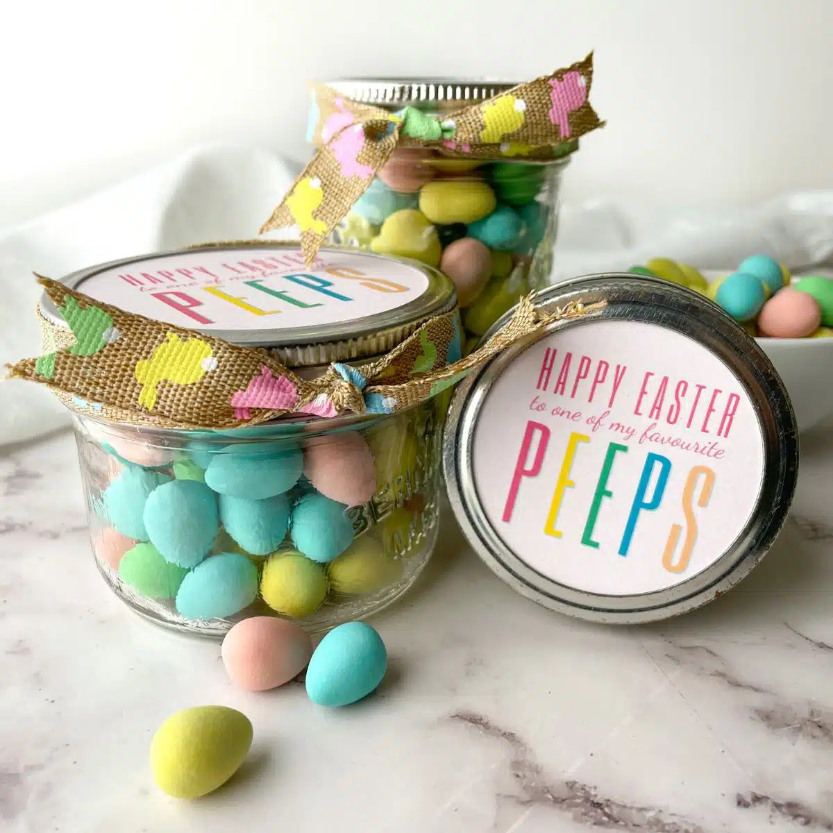 small mason jars filled with Easter treats.