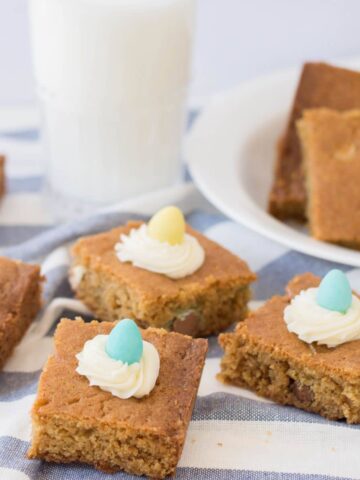 Blondie Bars with candy eggs and glass of milk.