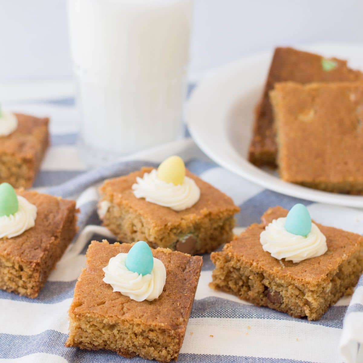 Blondie Bars with candy eggs and glass of milk.