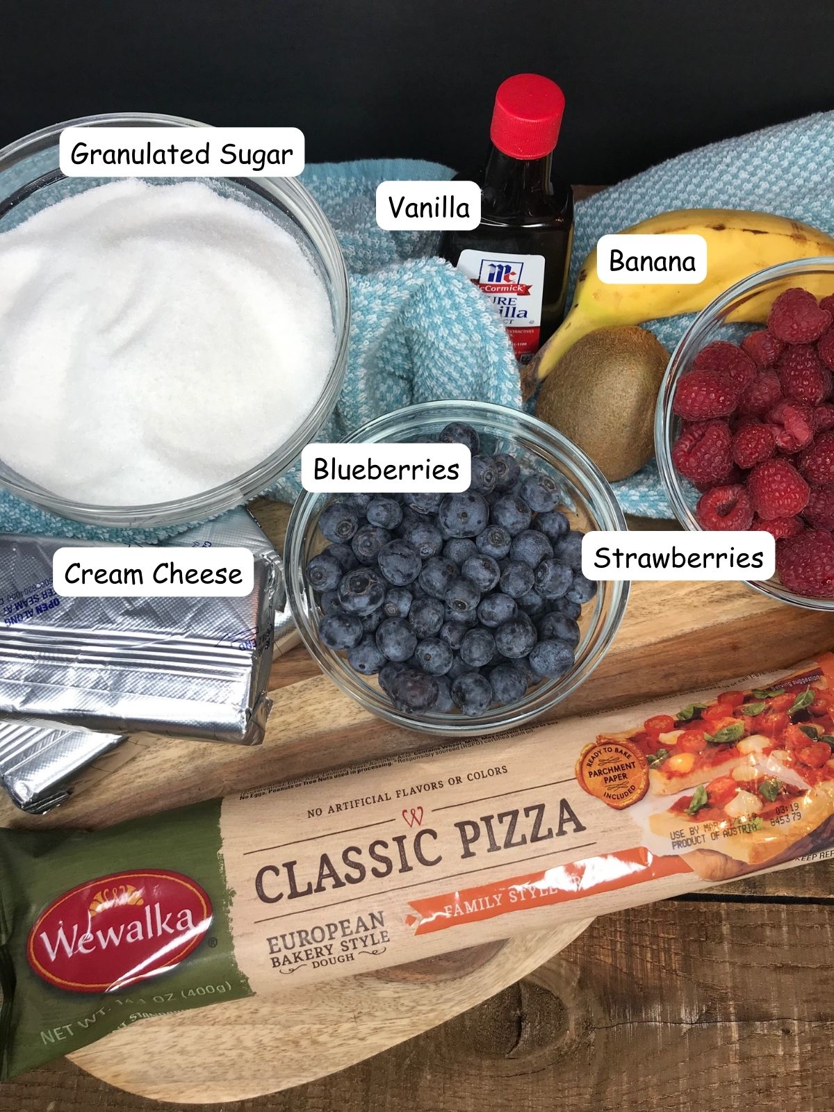 cream cheese, pizza dough, blueberries, strawberries, sugar.