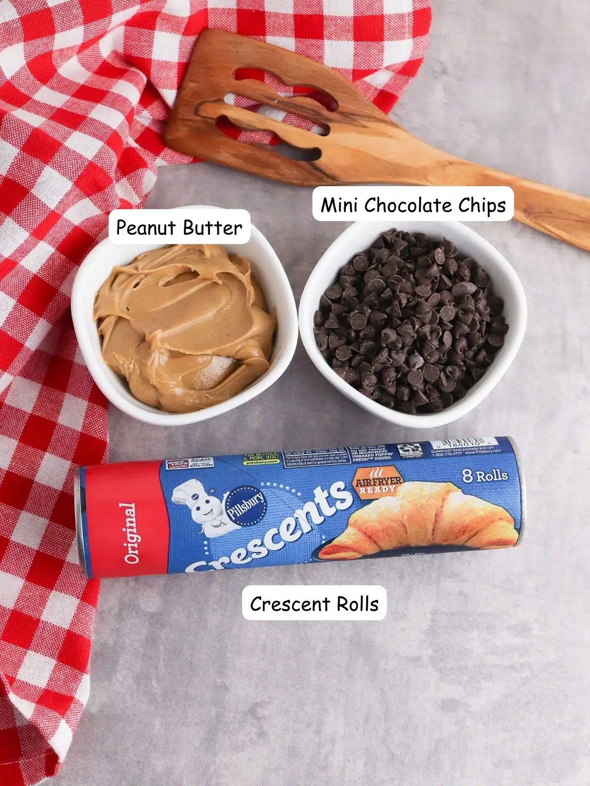 ingredients - peanut butter in small bowl, chocolate chips in bowl and container of crescent rolls.