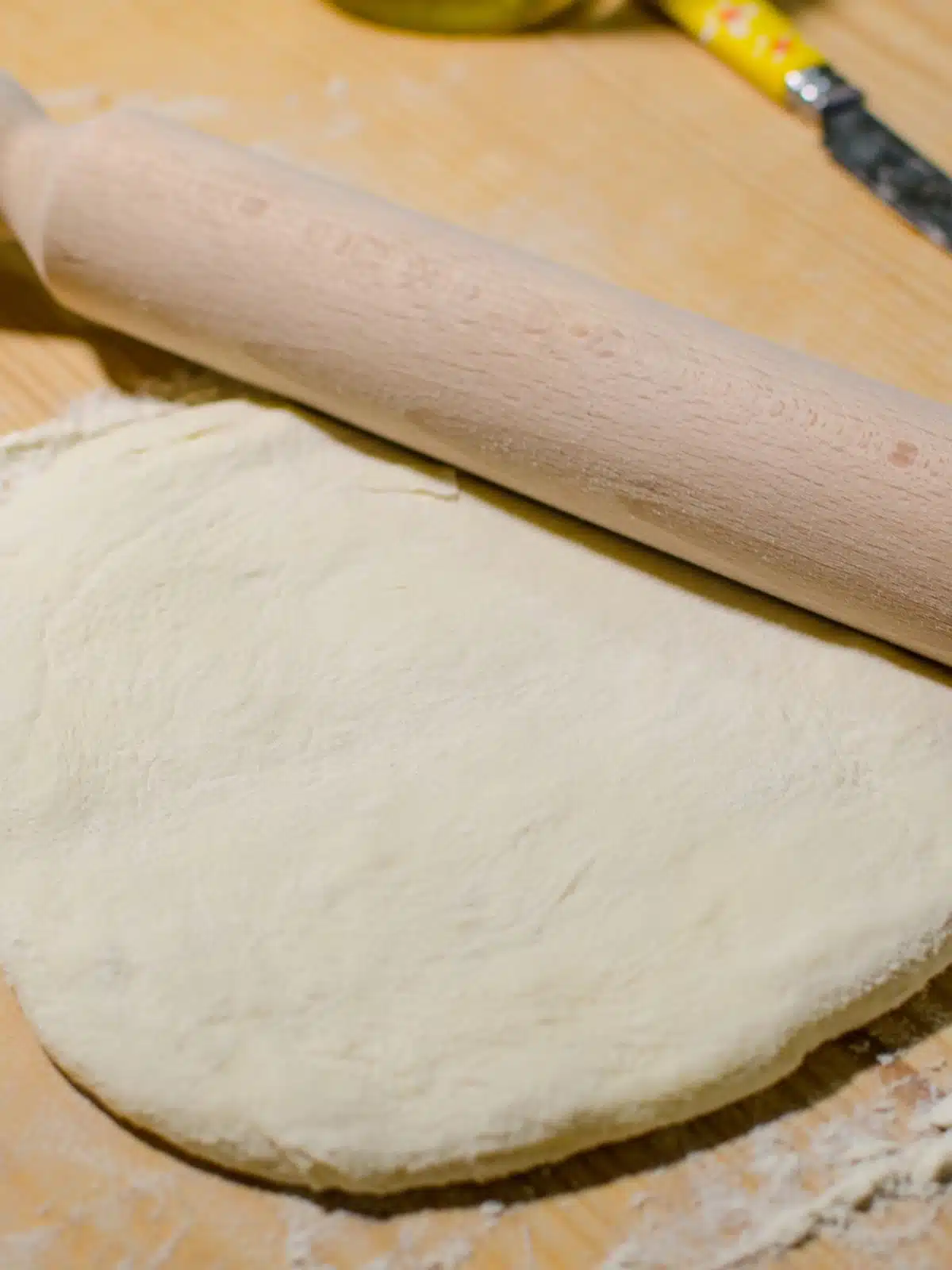 roll out pizza dough on cutting board.