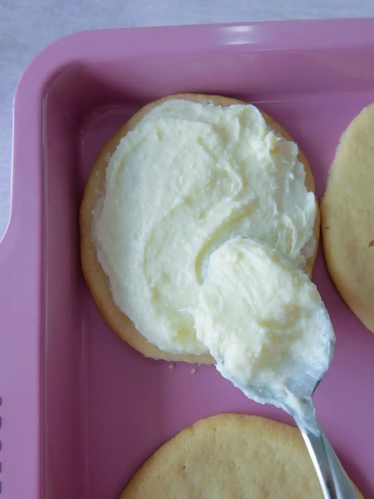 cream cheese frosting spread on egg-shaped sugar cookie.