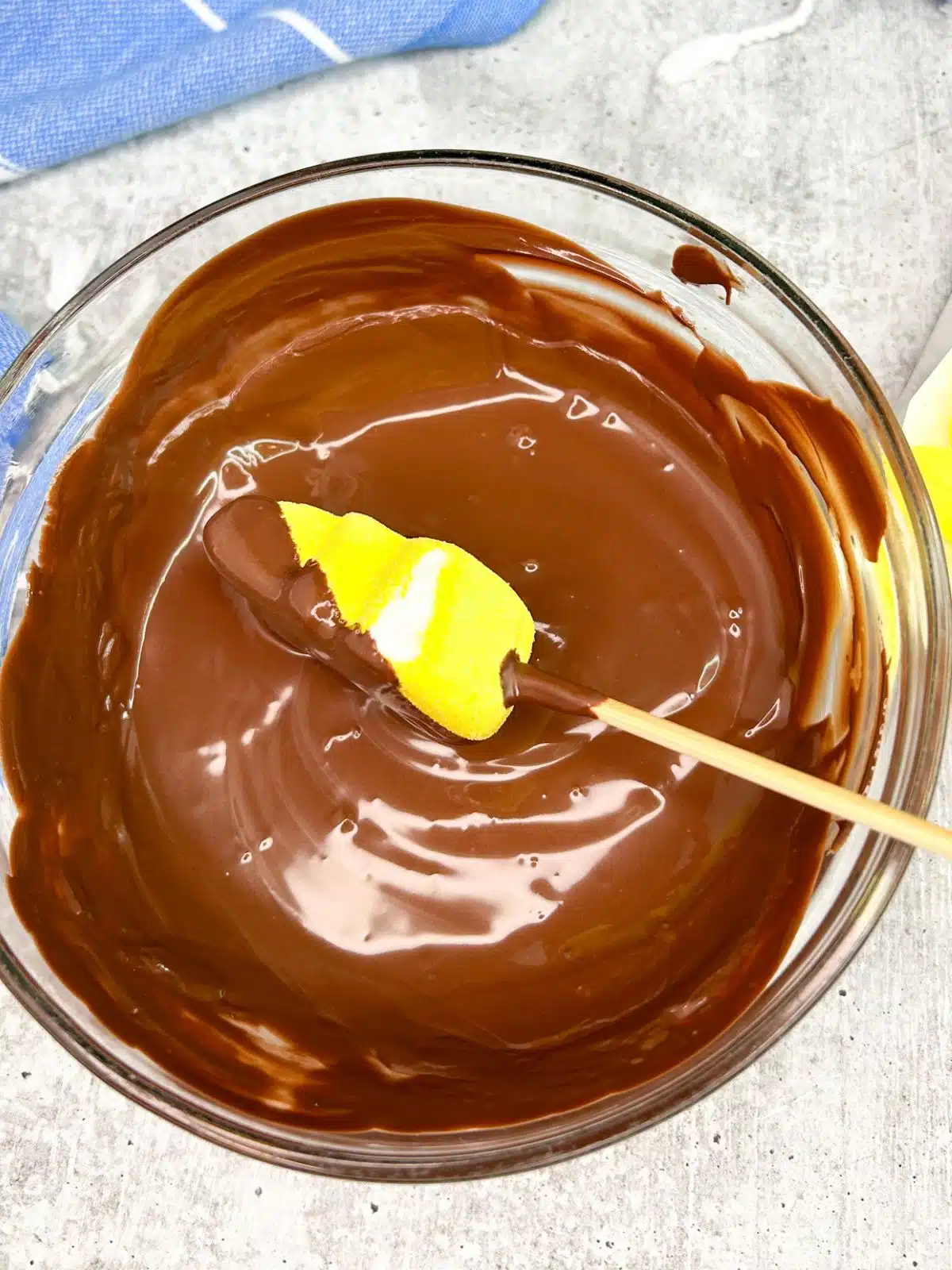 dip yellow marshmallow Peep in melted chocolate.