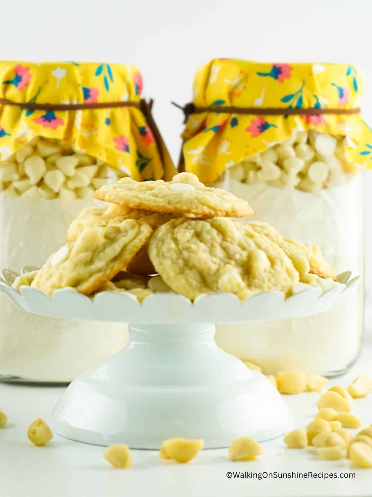baked cookies on white tray with mason jar mixes in background.