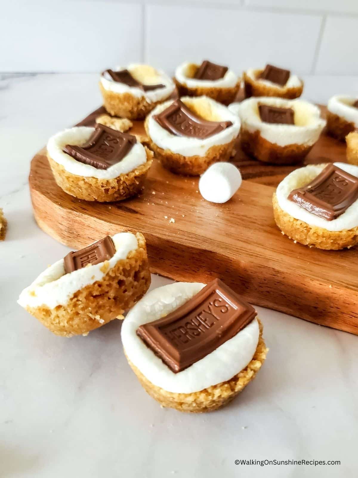 smores in graham cracker cups on cutting board.