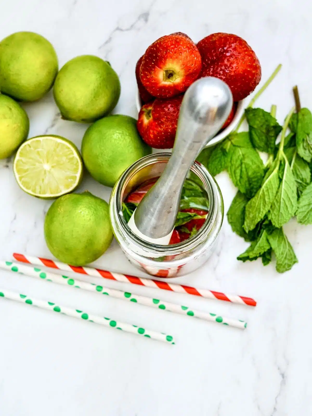 Add lime juice in glass with strawberries and mint.