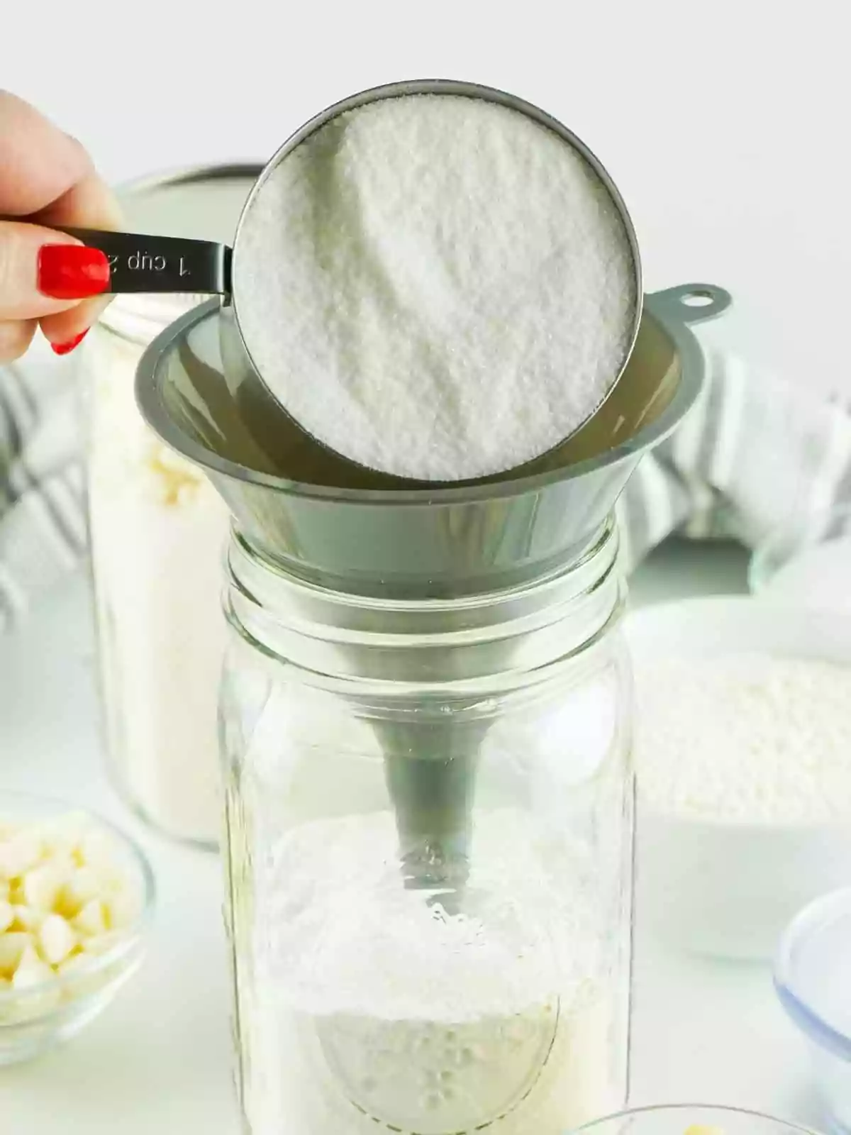add sugar to mason jar with a funnel.