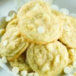 closeup of baked cookies with white chocolate chips and macadamia nuts.