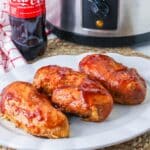 Barbecue Chicken served on a white platter with Coca Cola and a slow cooker in the background