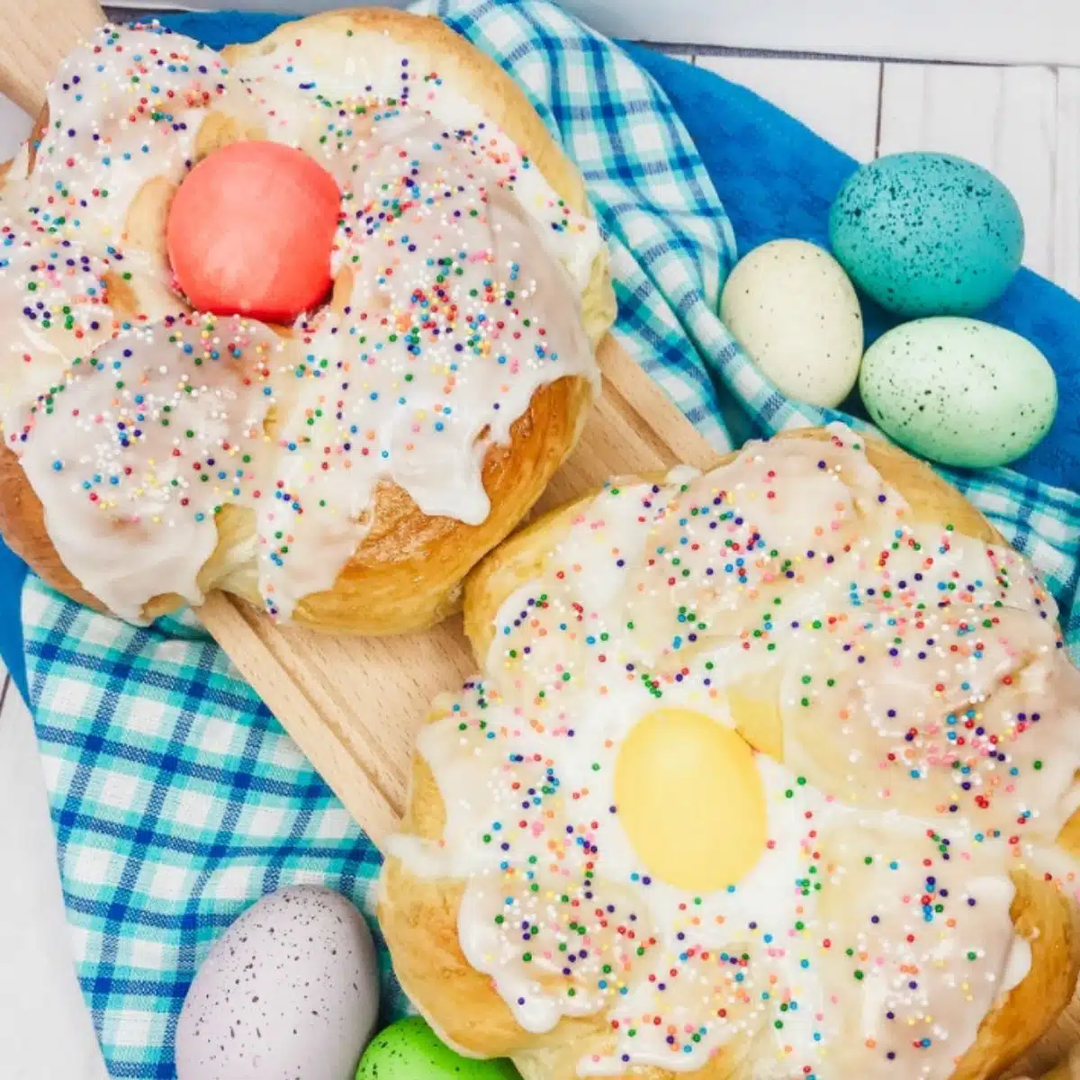 2 individual rings of Italian Easter Bread with icing and sprinkles.