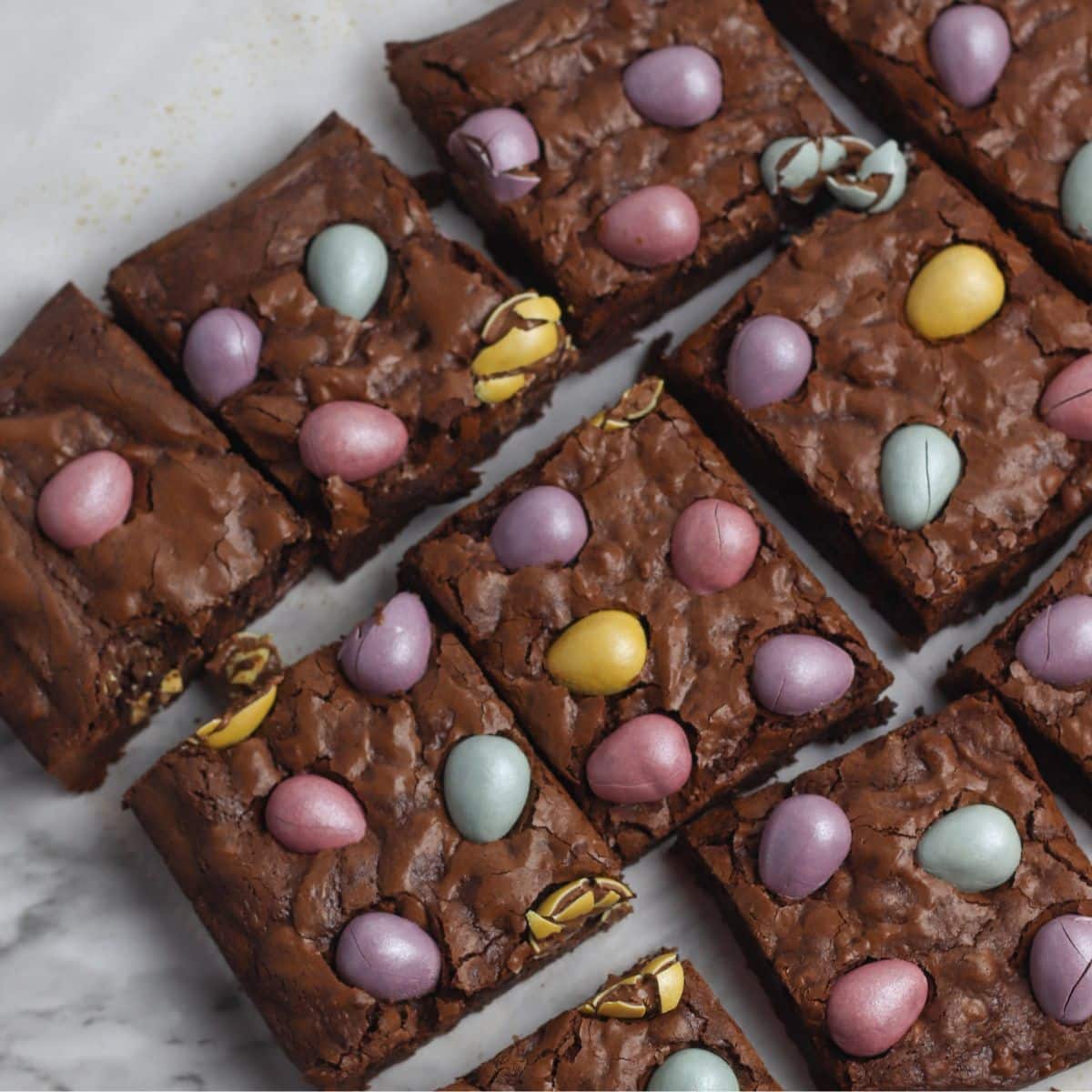 cadbury chocolate brownies on marble tray.