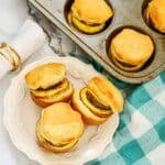 Biscuits with sausage, eggs and cheese on plate.