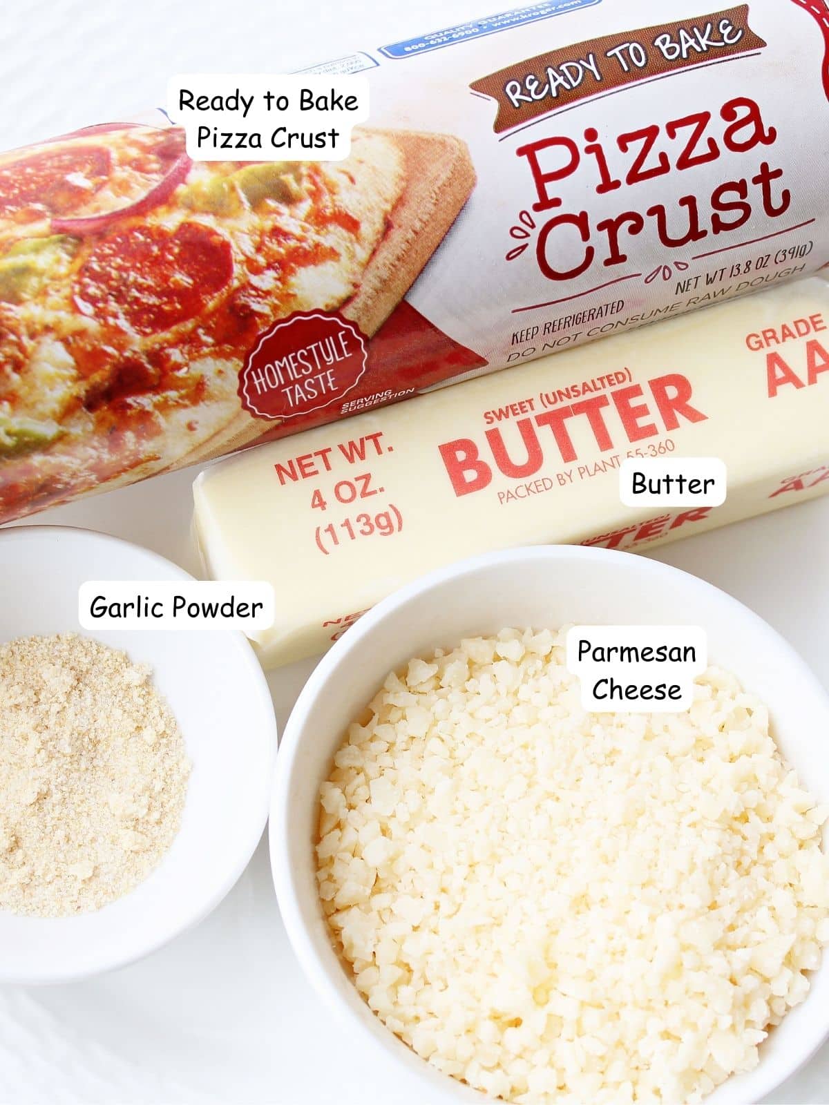 Ingredients Parmesan cheese, garlic powders, sticks of butter and refrigerator pizza dough.