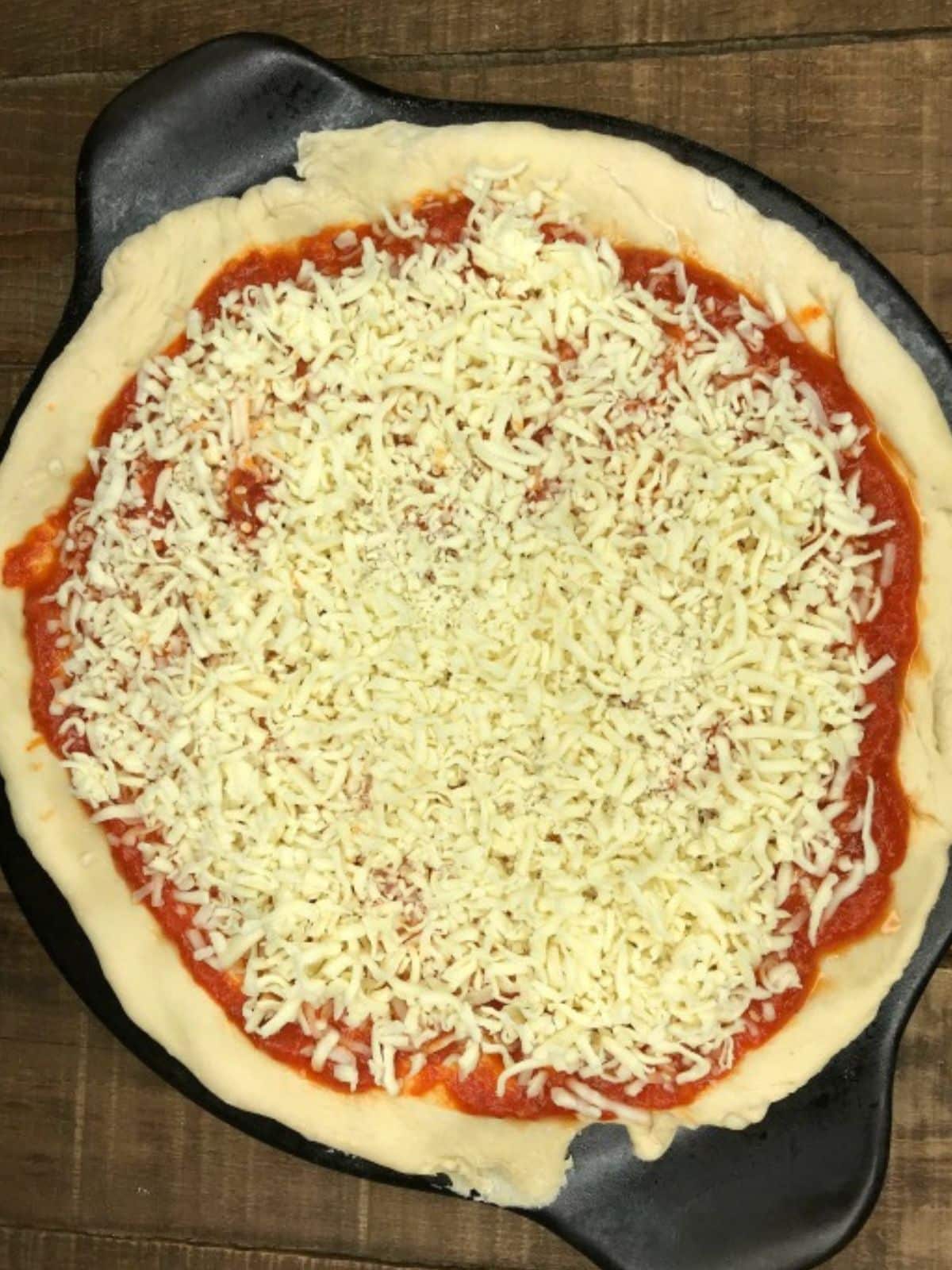 Add tomato sauce and mozzarella cheese.