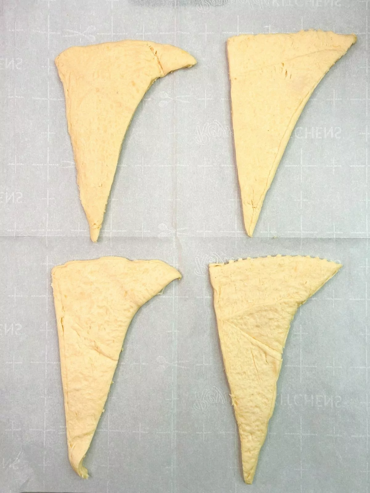crescent roll triangle dough on parchment paper.