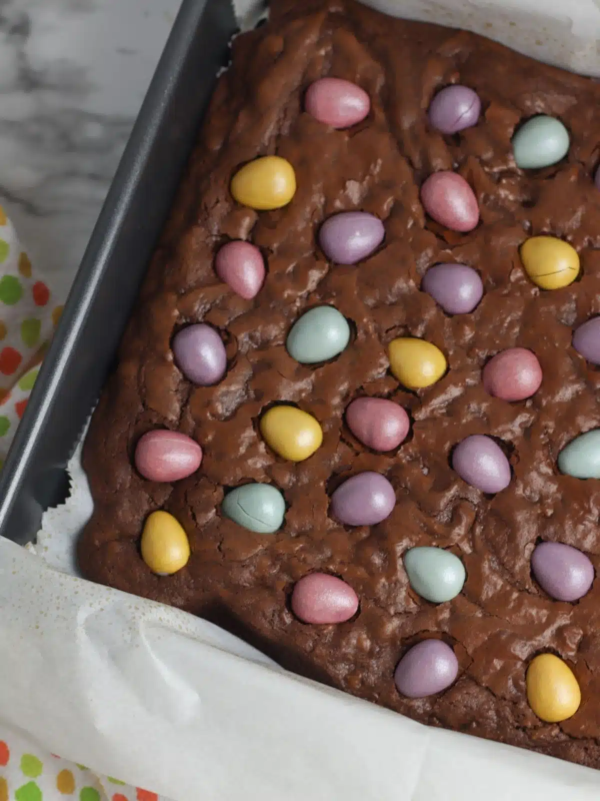 baked brownies in pan with candy eggs.