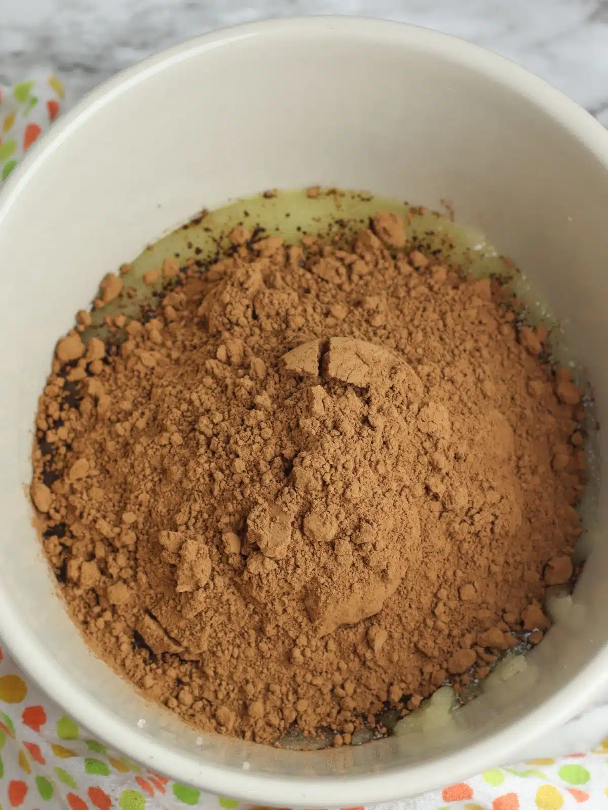 cocoa powder in bowl with eggs.