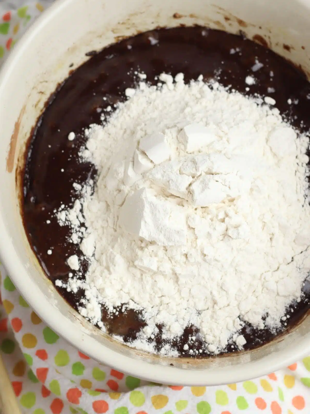 add flour to chocolate mixture in bowl.