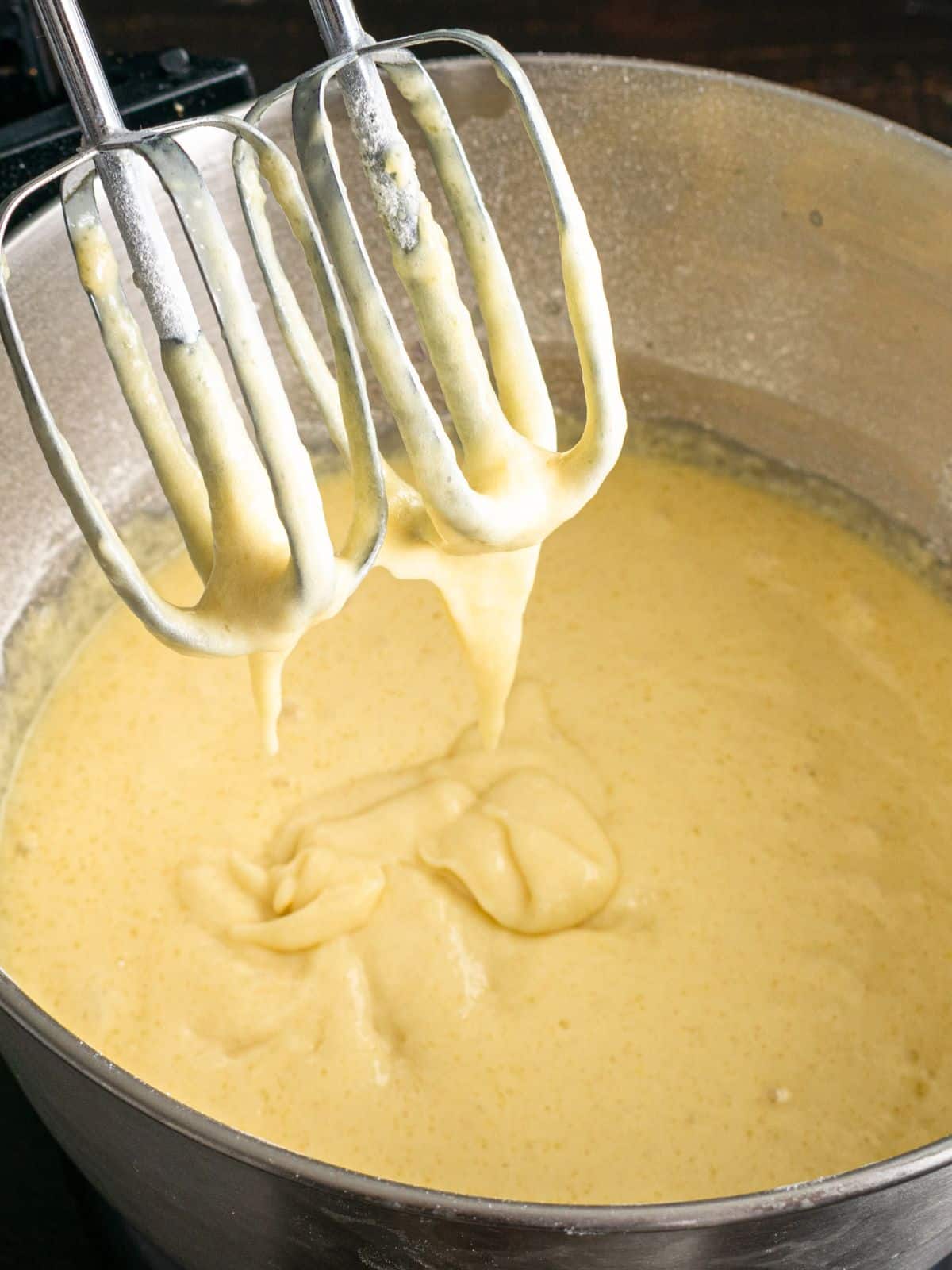 cake batter in bowl with electric beaters.